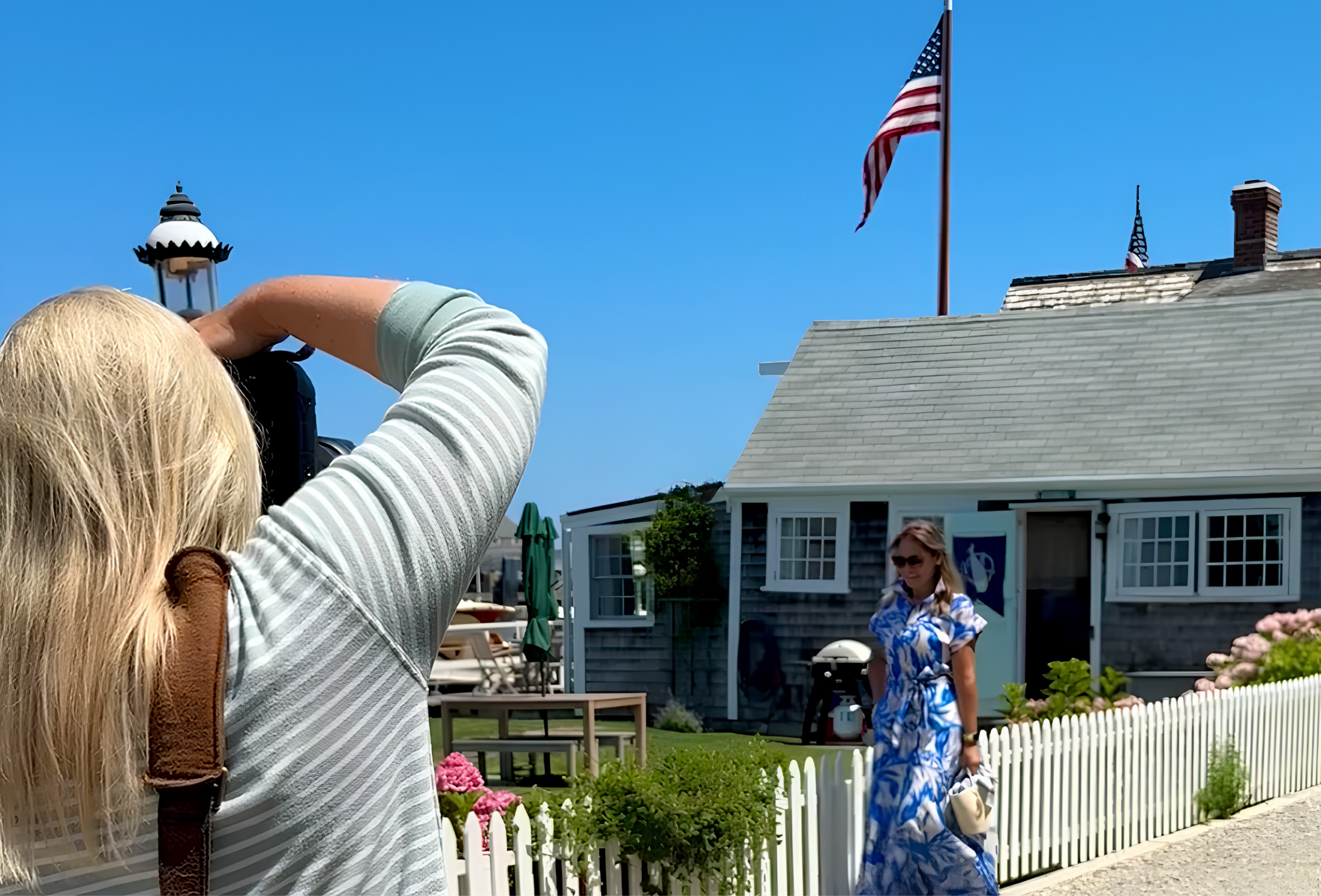 Nantucket photographer Rebecca Love photographing a client outside a classic shingled cottage